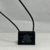 An ADP370M305J 3 uF 370 VAC black electrical capacitor with two black wires extending from the top, featuring technical specifications in white text on the front, standing on a white surface against a light gray background.