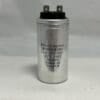 A BTC250E256J 25 μF 250 VAC Capacitor (6100-9188) with a silver cylindrical body stands upright on a white surface, featuring two terminals on top and black printed specifications along the side.