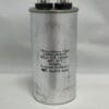 A silver cylindrical DKS DOORKING 2600-103 CBB65-240R656 65 uF 240 VAC Capacitor (003014.13), labeled with specifications of 65μF ±5%, 240VAC, 50-60Hz, Protected 10,000AFC, operating temperature range of 40°C to 85°C, Non PCB, RoHS compliant, featuring two black terminal connectors on top.