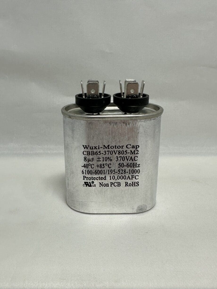 A Scotsman 18-3701-01 Run Capacitor (CBB65-370V805-M2), featuring a silver casing with two terminals on top, is labeled 8 µF ±10% 370 VAC, 50–60 Hz, has an operating temperature range of -40°C to 85°C, and displays various certifications printed on the front.