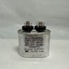 A silver cylindrical CBB65-440V305-M3 3 uF 440 VAC Capacitor (model 12027 A-8203-3.0), labeled Wuxi Motor Cap, features two terminals on top along with specifications such as 3μF, 440VAC, 50/60Hz, temperature ratings, and various certification marks against a plain background.