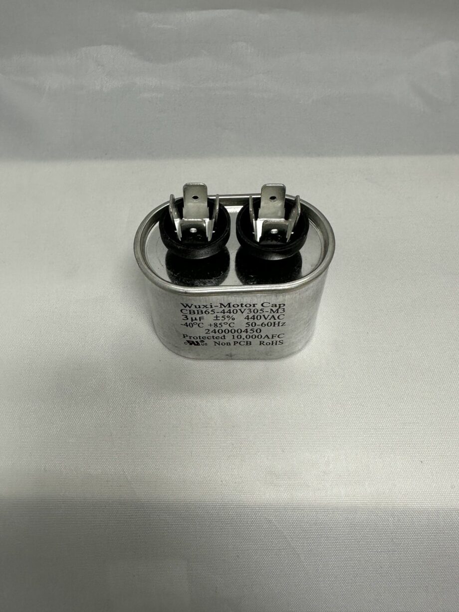 A CBB65-440V305-M3 3 uF 440 VAC capacitor (model 12027 A-8203-3.0) with a silver, oval-shaped body, two black terminals, metal connectors, and printed specifications sits on a white surface.
