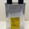 CH85-3000-744 0.74 uF 3000 VAC Microwave Capacitor w/ Internal Resistor, a metal high-voltage capacitor with two black terminals on top and a yellow warning label featuring technical specifications and a circuit diagram.